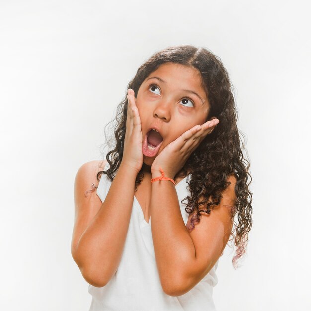 Portrait of a surprised girl over white background