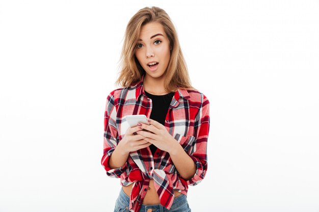 Portrait of a surprised pretty girl in plaid shirt