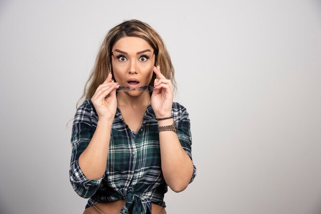 Portrait of surprised woman wearing stylish glasses. 