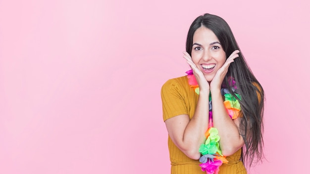 Portrait of a surprised young woman on pink background