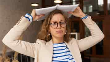 Free photo portrait teacher with book on head