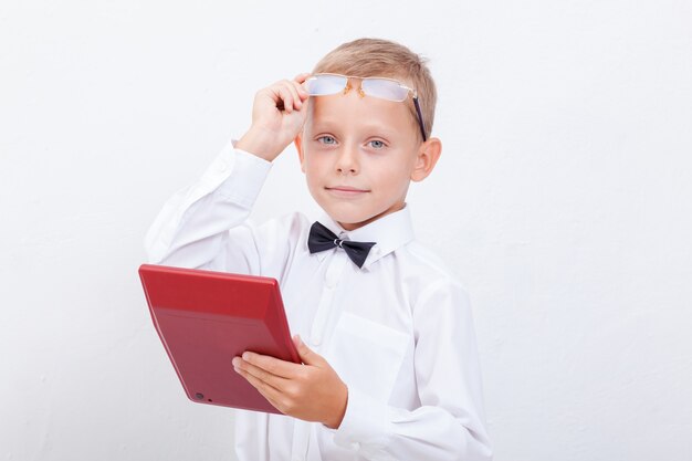 Portrait of teen boy with calculator on white background