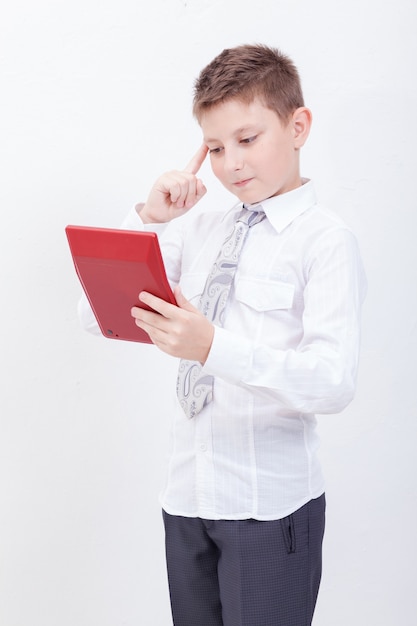 Portrait of teen boy with calculator on white background