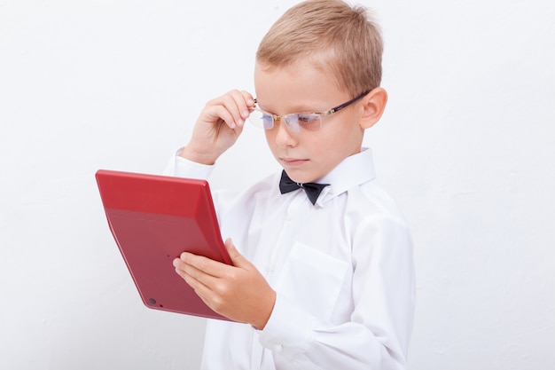 Portrait of teen boy with calculator on white