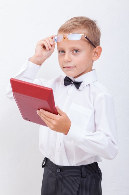 Portrait of teen boy with calculator on white