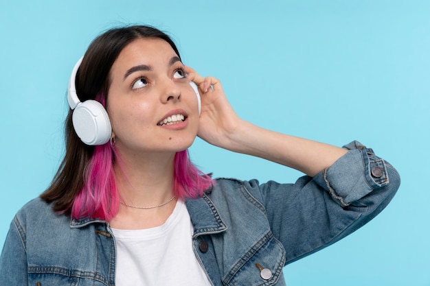 Portrait of a teen girl wearing headphones and listening to music