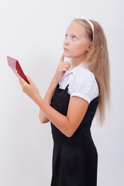 Portrait of teen girl with calculator on white