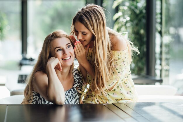 Portrait of teenage daughter and her mother having lunch together at the street cafe