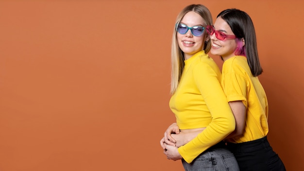 Portrait of teenage friends wearing sunglasses and holding their hands