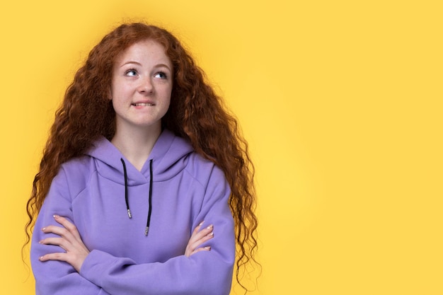 Portrait of teenage girl biting her lip