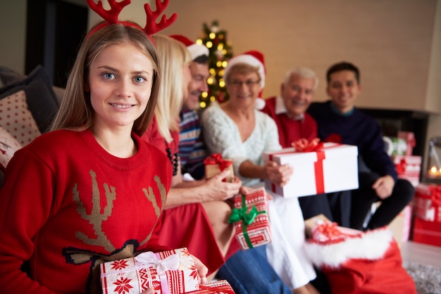 Portrait of teenage girl and her family in the background