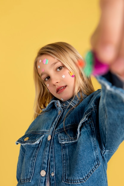 Portrait of teenage girl showing a sticker