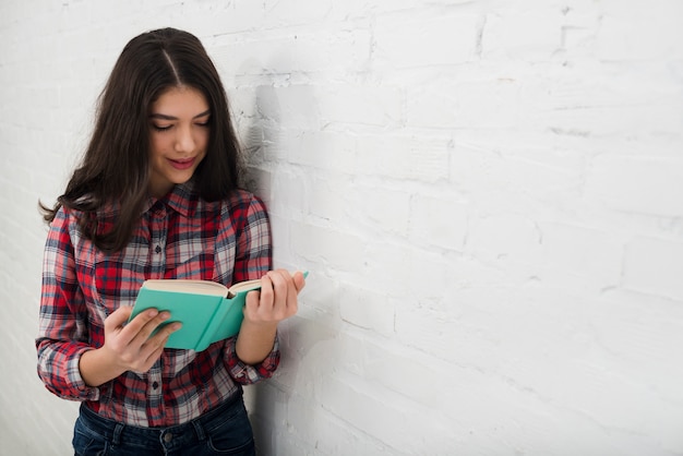 Portrait of teenage girl with book