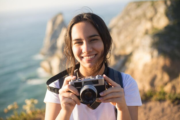 Portrait of teenage girl with camera smiling