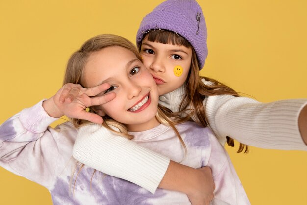 Portrait of teenage girls taking a selfie and showing the peace sign