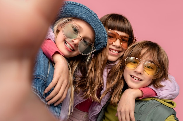 Portrait of teenagers taking a selfie and wearing sunglasses