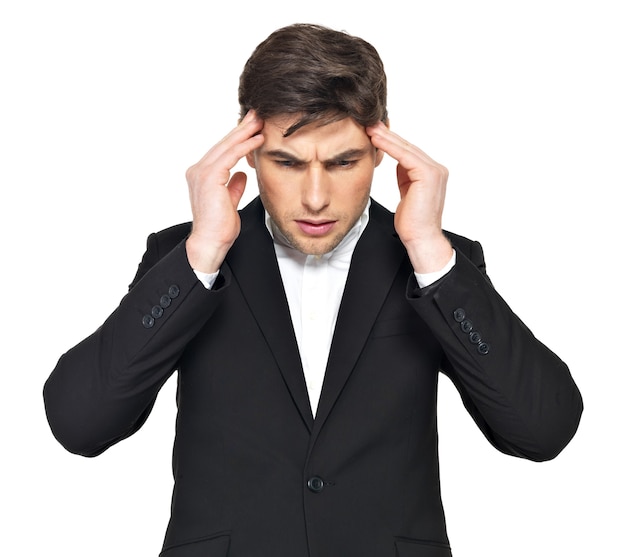 Portrait of the thinking businessman with hands at head. Portrait of a young man who is under heavy stress