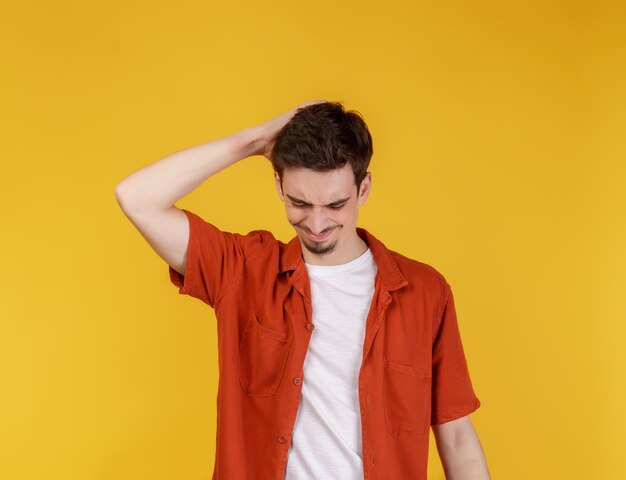 Portrait of thinking man surrounded by question mark on isolated background