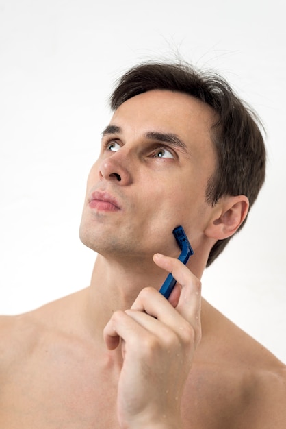 Portrait of a thinking man with razor blade