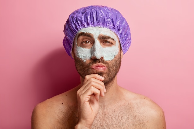 Portrait of thoughtful male doing his beauty routine