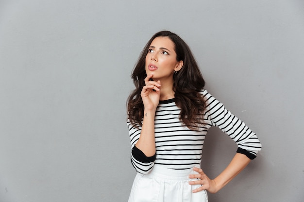 Portrait of a thoughtful woman looking away at copy space