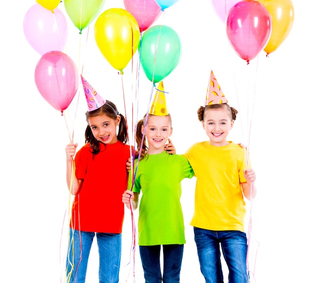 Портрет трех милых маленьких девочек с цветными воздушными шарами - изолированные на белом