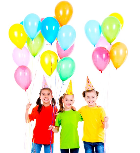 Portrait of three cute little girls with coloured balloons - isolated on a white