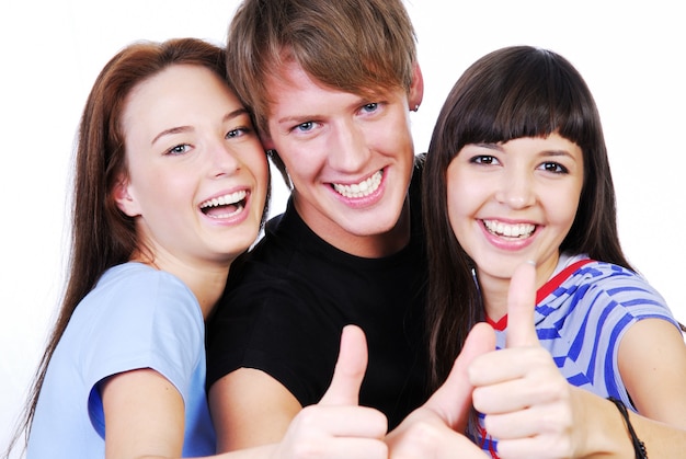 Free photo portrait of a three young teenagers laughing and giving the thumbs-up sign.