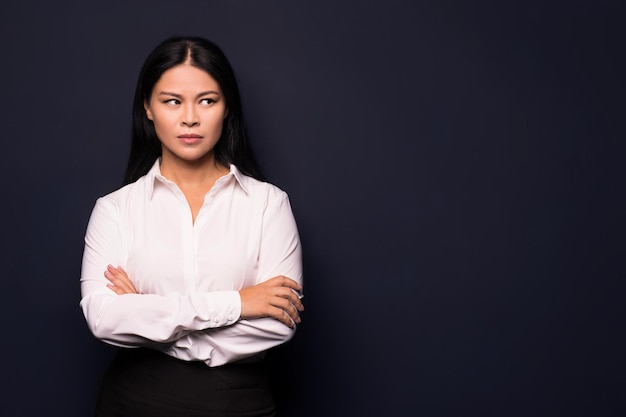 Portrait of tired young business woman Looking angrily Isolated on dark background