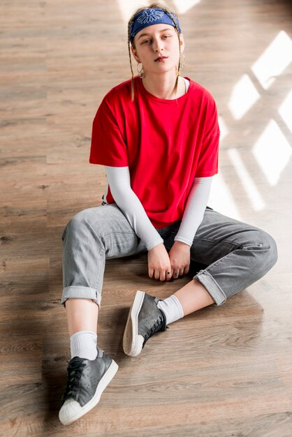 Portrait of a tired young woman relaxing in dance studio