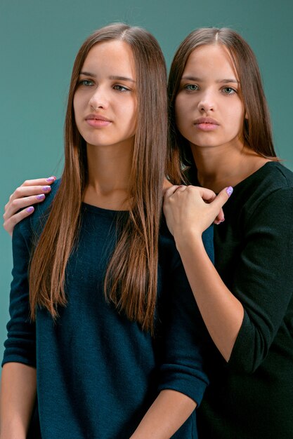 Portrait of two beautiful twin young women