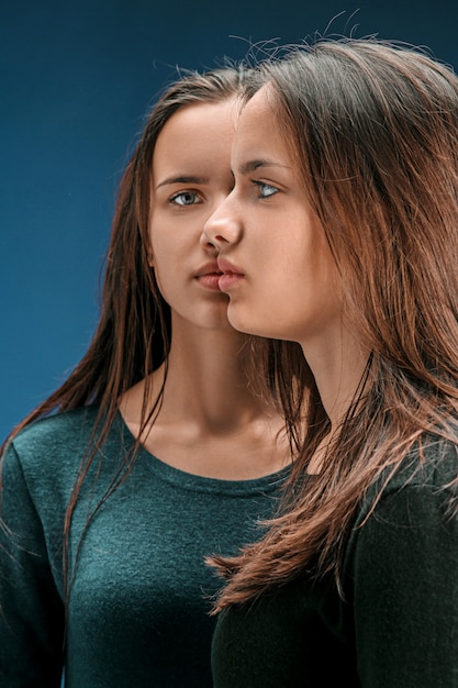 Portrait of two beautiful twin young women