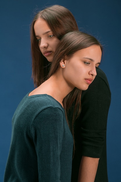 Portrait of two beautiful twin young women