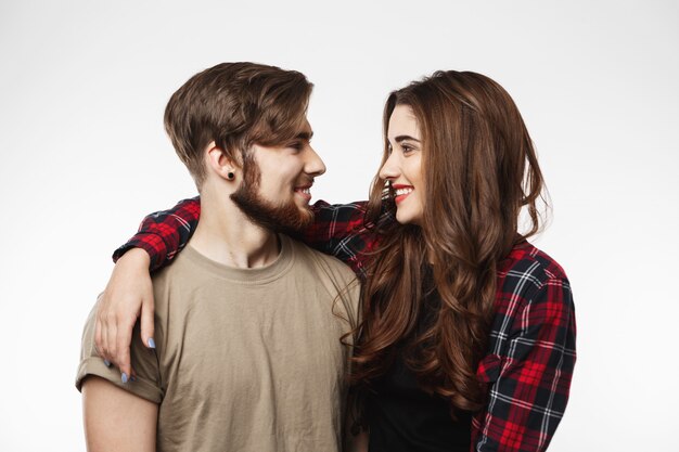 portrait of two best friends on white wall