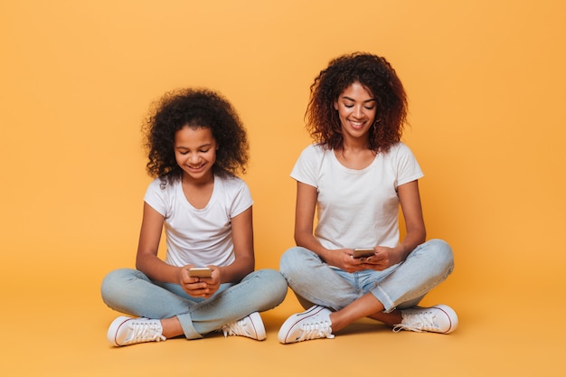 Portrait of a two cheerful afro american sisters