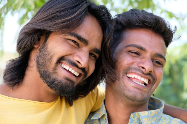 Portrait of two cheerful Indian friends in an outdoor place