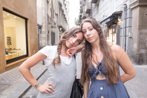 Portrait of two female friends standing in street