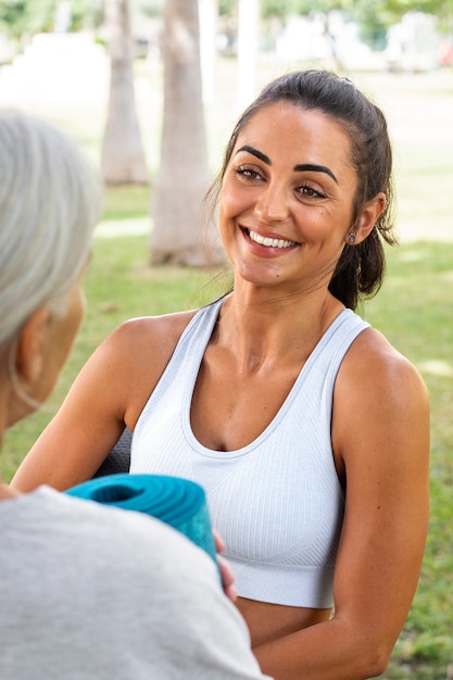 Free photo portrait of two female friends with different ages outdoors