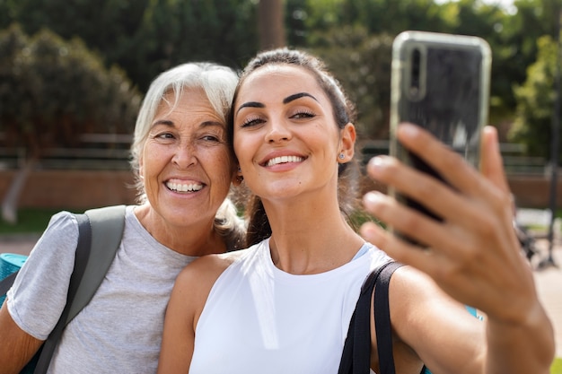 Free photo portrait of two female friends with different ages outdoors