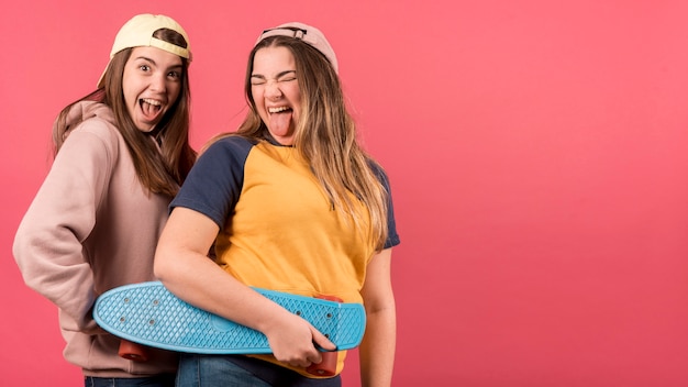 Portrait of two girls on red background