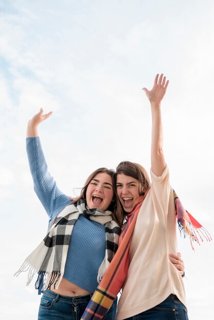 Portrait of two girls on sky background