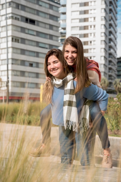 Portrait of two girls in urban environment having fun