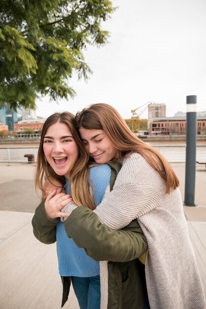 Portrait of two girls in urban environment having fun