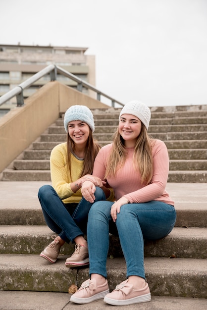 Free photo portrait of two girls in urban environment having fun