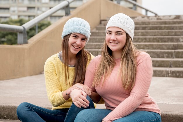 Portrait of two girls in urban environment having fun