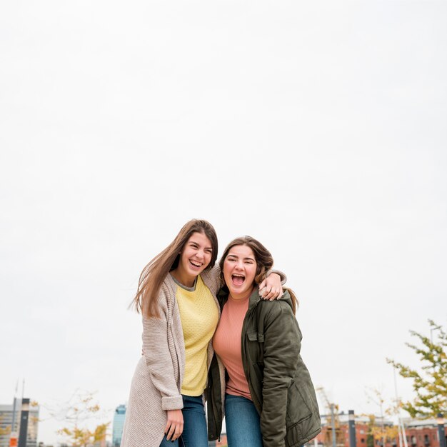 Portrait of two girls in urban environment having fun