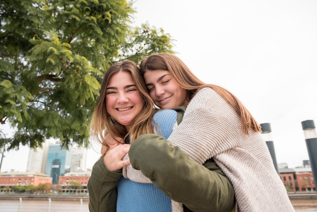 Portrait of two girls in urban environment having fun