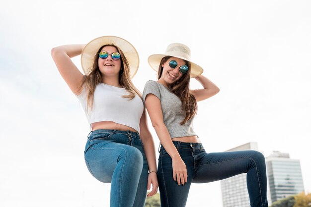 Portrait of two girls in urban environment having fun