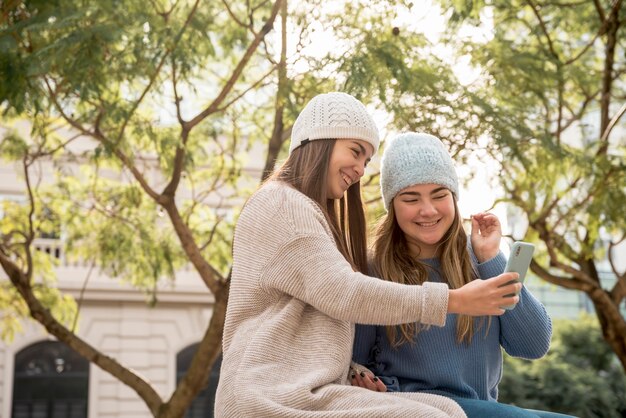 Portrait of two girls in urban environment having fun