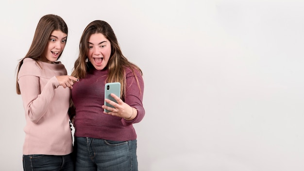 Portrait of two girls on white background